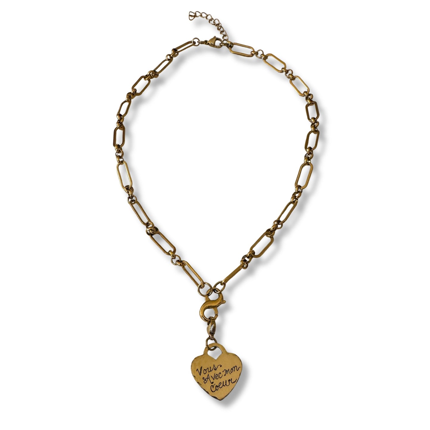 Gold chain necklace with a heart-shaped pendant on a white background