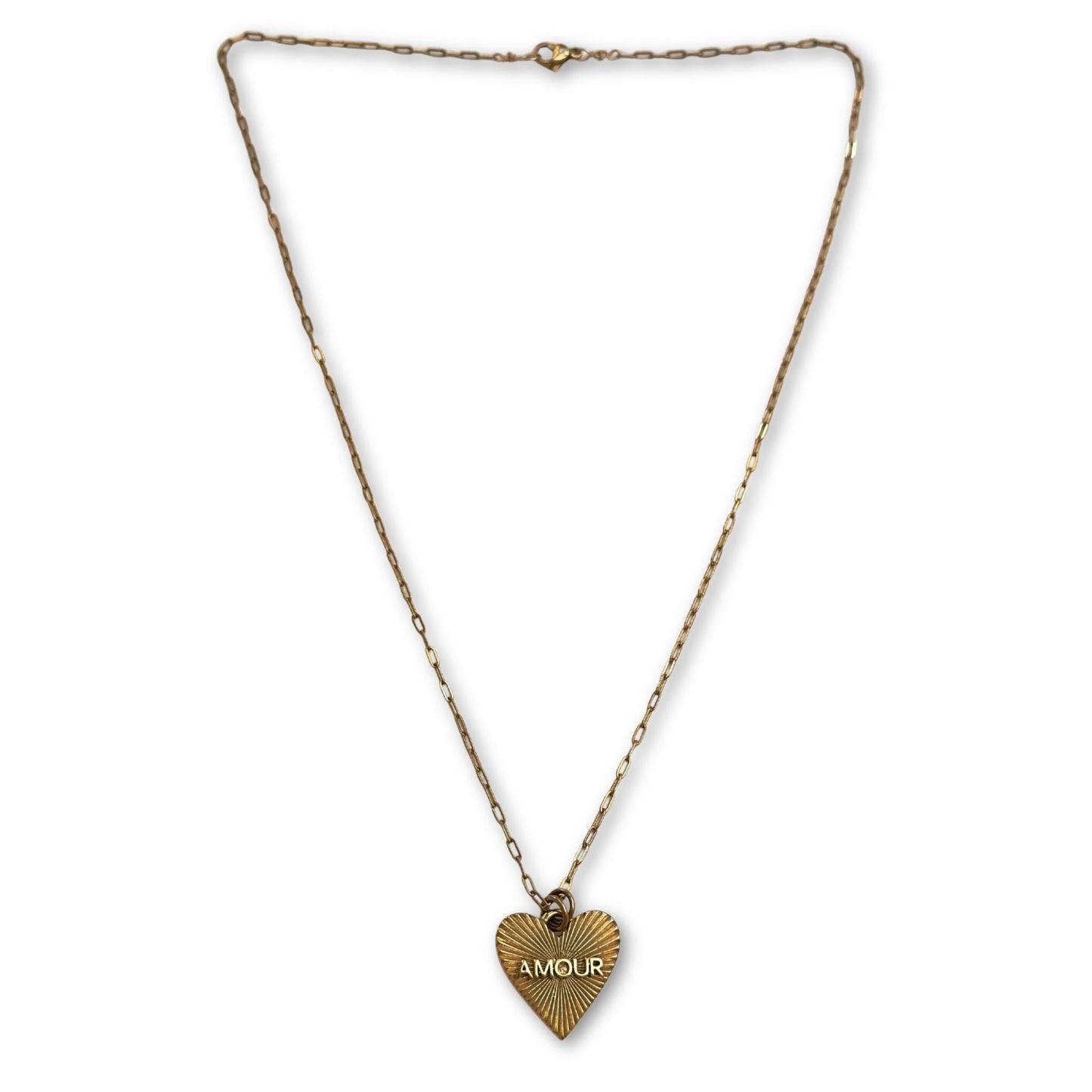 Gold heart-shaped pendant necklace with 'AMOUR' engraving on a white background