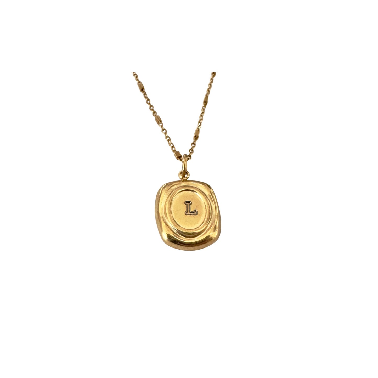Gold necklace with a pendant featuring the letter 'L' on a white background