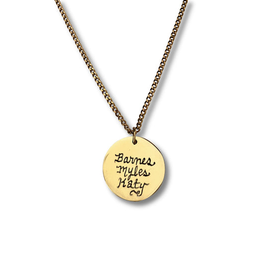 Gold pendant round disc necklace featuring family names in script