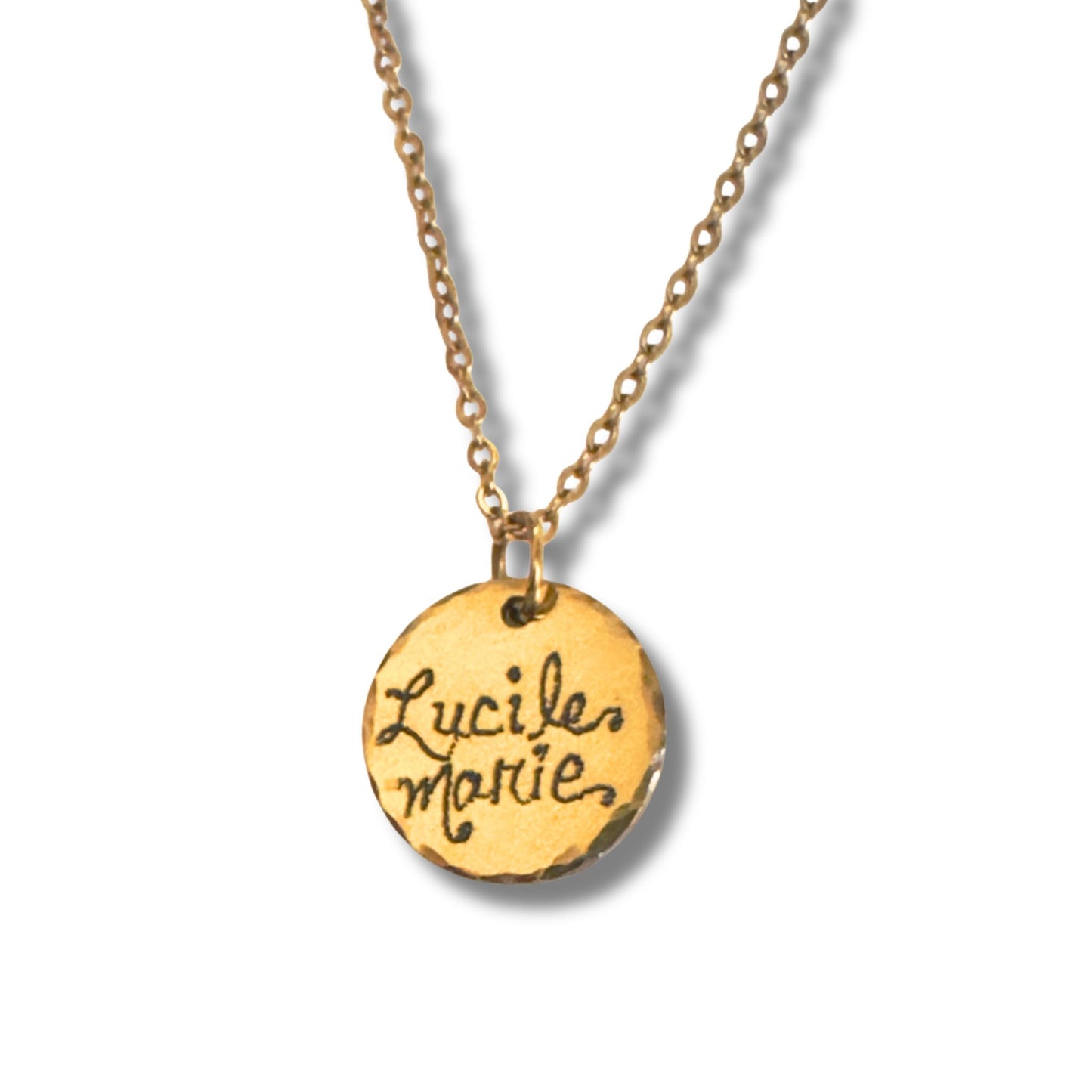 Engraved gold pendant in script featuring a name close up