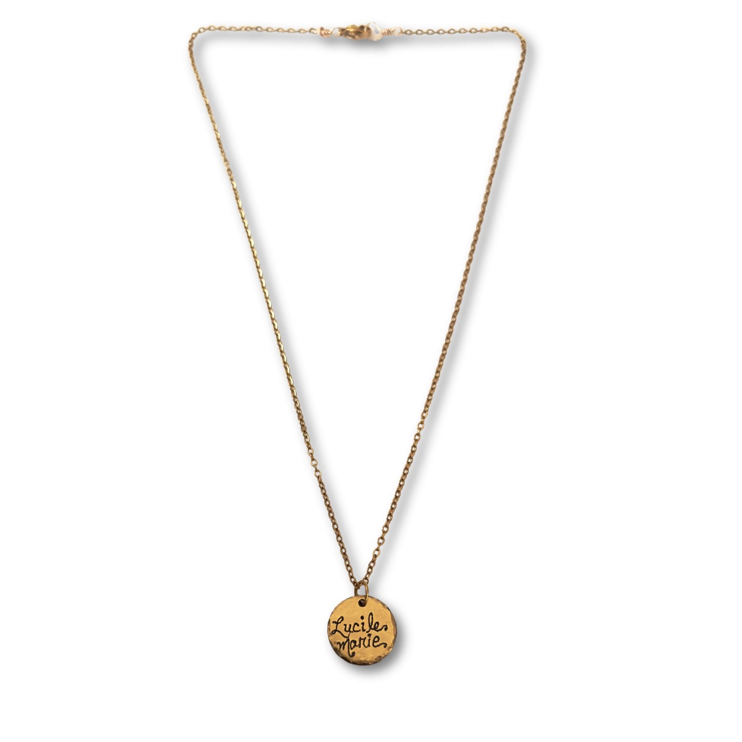 Gold necklace with engraved gold pendant in script featuring a name